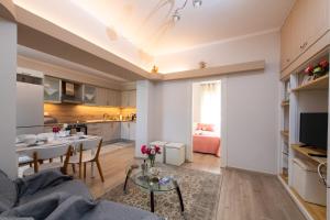 a living room with a couch and a table at SPYROS APARTMENT in Diakopto