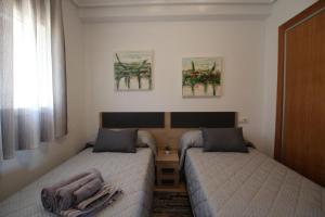 Postel nebo postele na pokoji v ubytování Adosado Roldán by Rental Olé + 12 fotografií