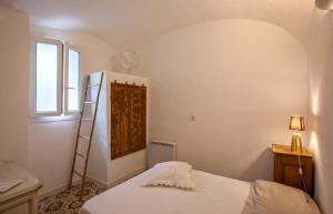 um quarto com uma cama com uma escada e uma janela em Casa Rione em Omessa