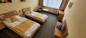 Postel nebo postele na pokoji v ubytování Hotel Cascade