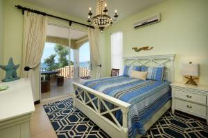 a bedroom with a bed and a view of the ocean at Beachfront Potrero - nice 7-BR villa, private cook included - Casa Royal in Potrero +42 photos
