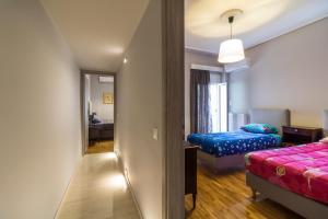 a hotel room with two beds and a mirror at Comfortable and Spacious 2 bdr Apt in Athens