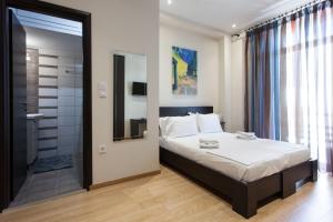 a bedroom with a bed and a walk in shower at Artistic 3 bedroom apartment with sea view in Glyfada in Athens