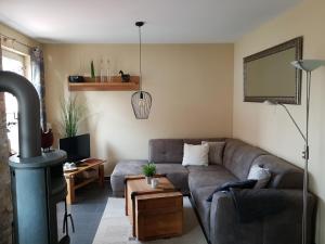 a living room with a couch and a wood stove at Dat Diekhus in Greetsiel