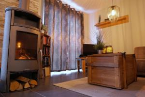 a living room with a fireplace in a living room at Dat Diekhus in Greetsiel