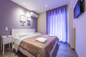 a bedroom with a large bed with purple walls at An Impressive 2 bdr Apt in Glyfada in Athens