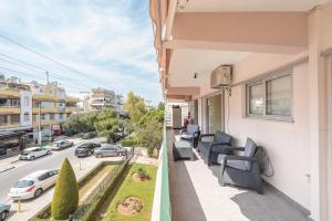 a balcony with chairs and a view of a street at An Impressive 2 bdr Apt in Glyfada in Athens