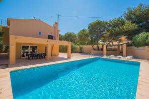 a swimming pool in front of a house at Villa Bernia - PlusHolidays in Moraira