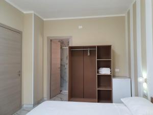 a bedroom with a bed and a closet and a door at B&B La Leggenda in Vieste +6 photos