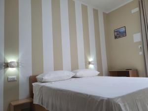 a bedroom with a bed with two pillows on it at B&B La Leggenda in Vieste
