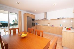 a kitchen with a table with a bowl of bananas on it at Villa Ermita by Sonne Villas in Cala Galdana