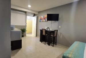 a living room with a kitchen and a table in it at 8th Street Suites in Cozumel