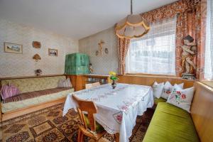 een eetkamer met een tafel en een bank bij Apartment Raieta in Ortisei