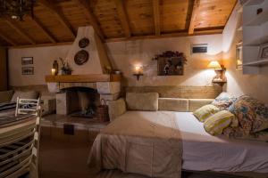 a bedroom with a large bed and a fireplace at Studio Zavala in Zavala