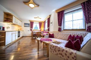 a living room with a couch and a table at Apartments Miara in Santa Cristina in Val Gardena