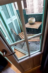 a view through a window of a table and bench at Superbe studio balcon Plage/ Prom. des Anglais 103 in Nice