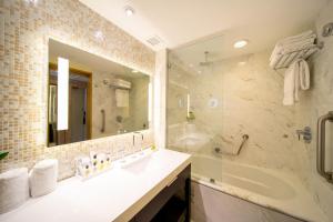 ein Badezimmer mit einer Badewanne, einem Waschbecken und einem Spiegel in der Unterkunft Hotel Real InterContinental San Pedro Sula, an IHG Hotel in San Pedro Sula