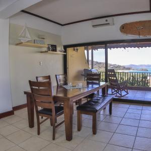 a dining room with a table and chairs and a balcony at Presidential Suites 4 - Spacious condo in the heart of Flamingo, sleeps 6 in Playa Flamingo
