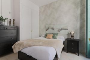 A bed or beds in a room at C32 - Cosy Getaway in the Historical Center of Malaga