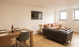 a living room with a table and a couch at no 1 Wood Street in Swindon