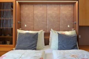 a bed with two pillows and a headboard at Apartment Nogler Frieda in Selva di Val Gardena