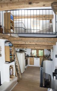 an open kitchen and living room with a loft at Rain Apartment with private spa area-Zorten-Lenzerheide in Obervaz