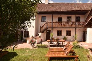 a house with a patio with a table and a deck at Penzion Marcipánka in Třeboň