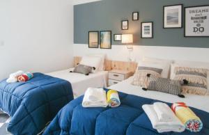 two beds in a room with blue and white at Chalet Mediterráneo Bolnuevo by Rental Olé in Puerto de Mazarrón