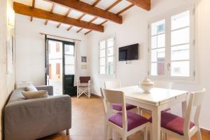 a living room with a table and a couch at ROQUES 24 in Ciutadella