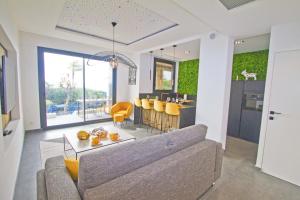 a living room with a couch and a dining room at Luxury Garden Jacuzzi Promenade in Nice