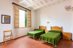 A bed or beds in a room at Camps 4 bedroom house, Ciutadella