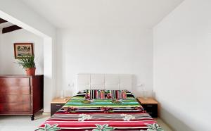 a bedroom with a bed and a dresser at Villa Aire in Punta Prima +23 photos