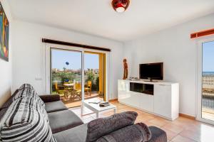 a living room with a couch and a tv at Villa Fiesta in Ciutadella