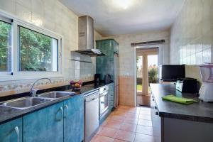 a kitchen with a sink and a counter top at Villa Fiesta in Cala en Blanes