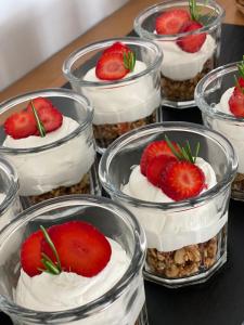 a group of cupcakes with strawberries on top of them at Hermes Hotel in Kamari