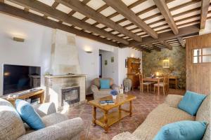 a living room with couches and a fireplace at Villa Gregal in Cala Blanca