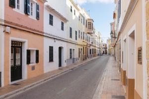an empty street in an alley with buildings at SA FONT in Ciutadella