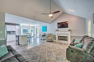 a living room with a couch and a fireplace at Charming Ranch-Style Home Near Lake Lanier! in Gainesville