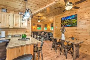 una cucina in legno e un soggiorno con tavolo e sedie di Almost Heaven Too 50-Acre Escape with Pond! a Brownsville Altre 31 foto