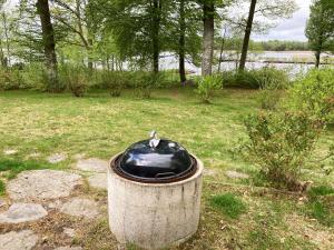a bird sitting on top of a trash can at Nice holiday house located by the lake Bolmen in Ljungby