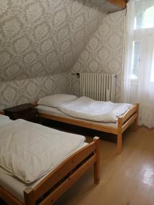 two beds in a room with a wall at středisko Doubrava in Zlaté Hory