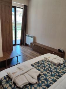una camera da letto con un letto con asciugamani sopra di Krystal Resort Apartment A108 a Bakuriani