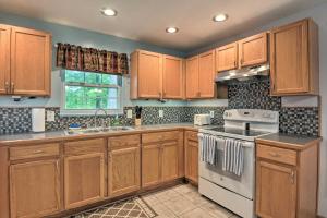 a kitchen with wooden cabinets and a stove top oven at Table Rock Lake Retreat Less Than 1 Mi to Boat Launch in Golden