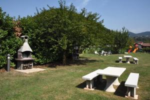 eine Gruppe Bänke in einem Park mit einem Baum in der Unterkunft Villa Gradoni in Monticelli Brusati