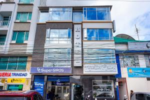 a tall building with windows on a city street at Ayenda Agustin Plaza in Pasto