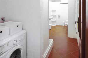 a white laundry room with a washer and dryer at Villa dell'Erta - Levanto in Montale