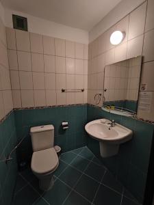 a bathroom with a toilet and a sink at Park Hotel Briz - All Inclusive & Free Parking in Golden Sands