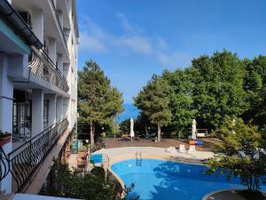 a view of a swimming pool next to a building at Park Hotel Briz - All Inclusive & Free Parking in Golden Sands