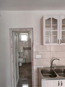 a small bathroom with a sink and a toilet at Apartment Panorama in Bar