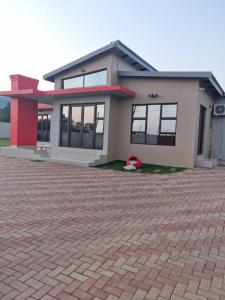 a house with a brick driveway in front of it at ONNIE GUESTHOUSE in Louis Trichardt